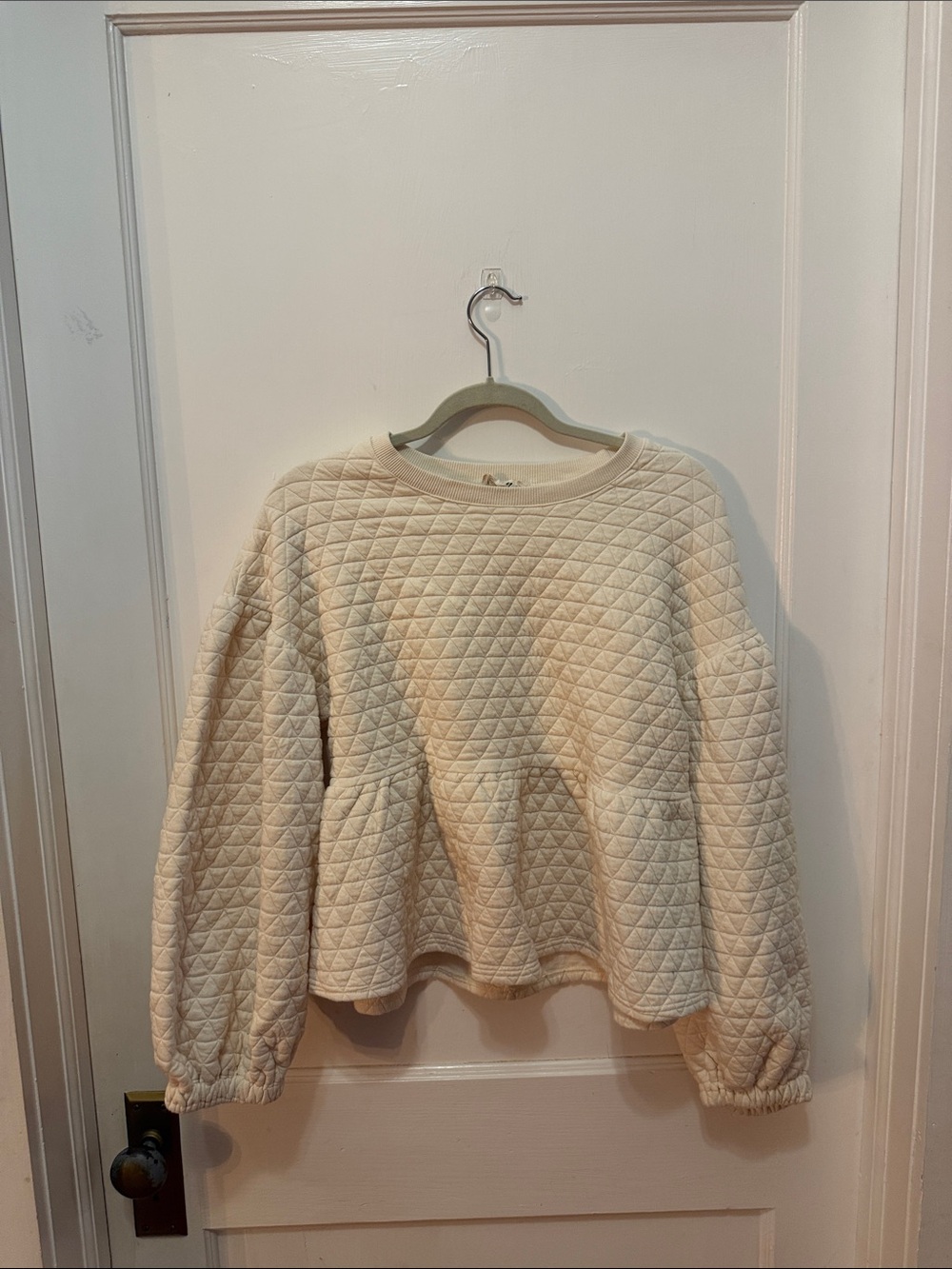 Cream Quilted Peplum Sweatshirt - Women - Picture 1 of 3